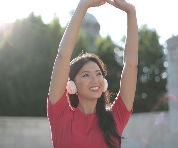 Person stretching outdoors enjoying the sunlight.